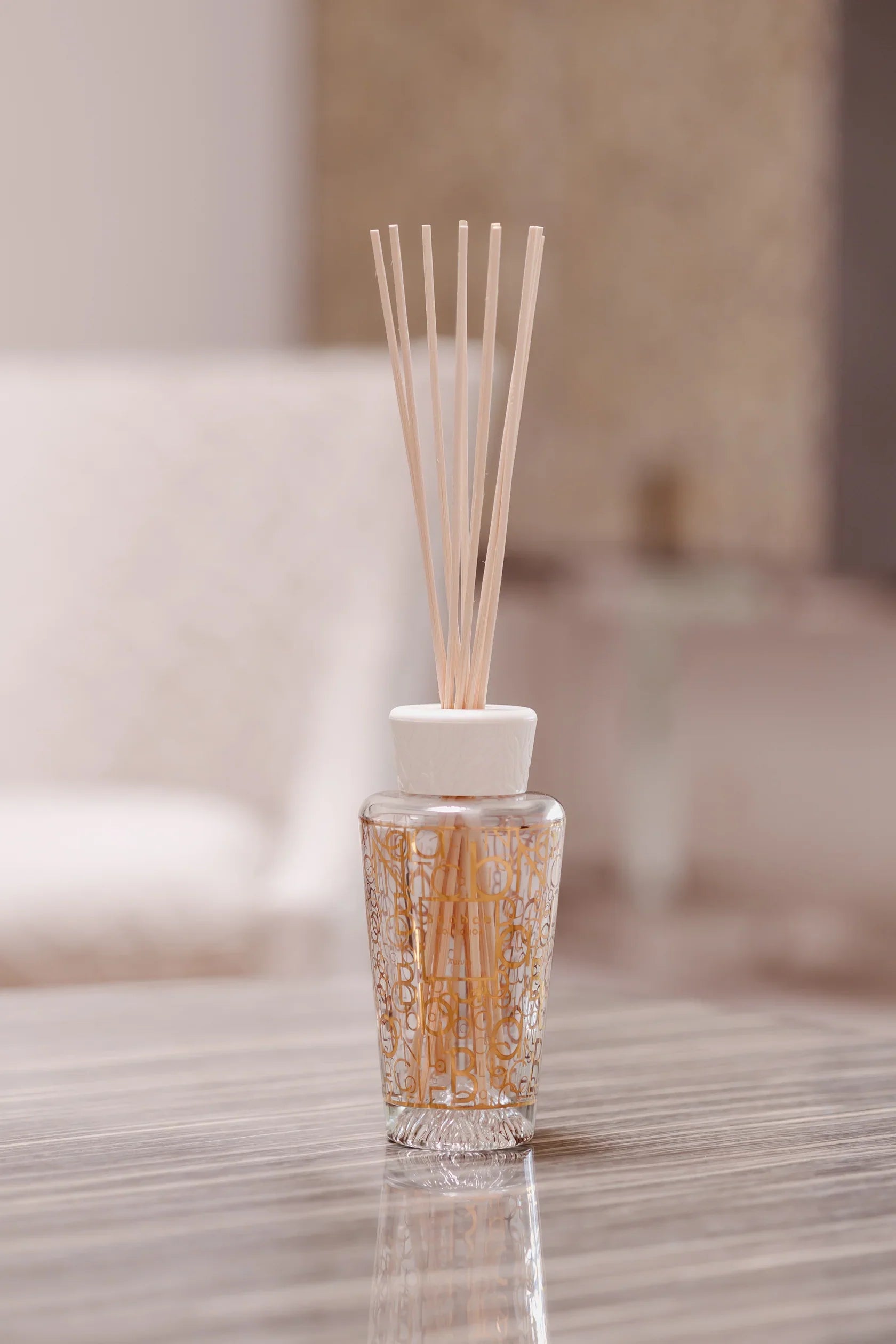 Baobab Collection My First Baobab Aurum diffuser with elegant design and rattan sticks on a stylish table.