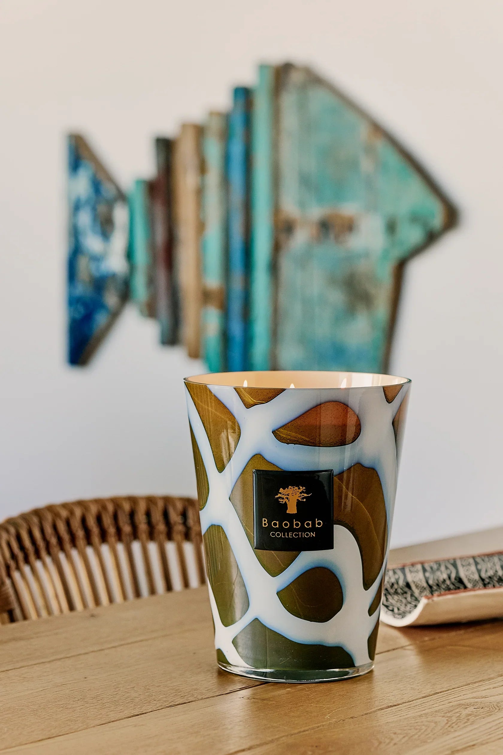 Baobab Collection Candle Stones Agate with unique glass design and peony scent, placed on wooden table.