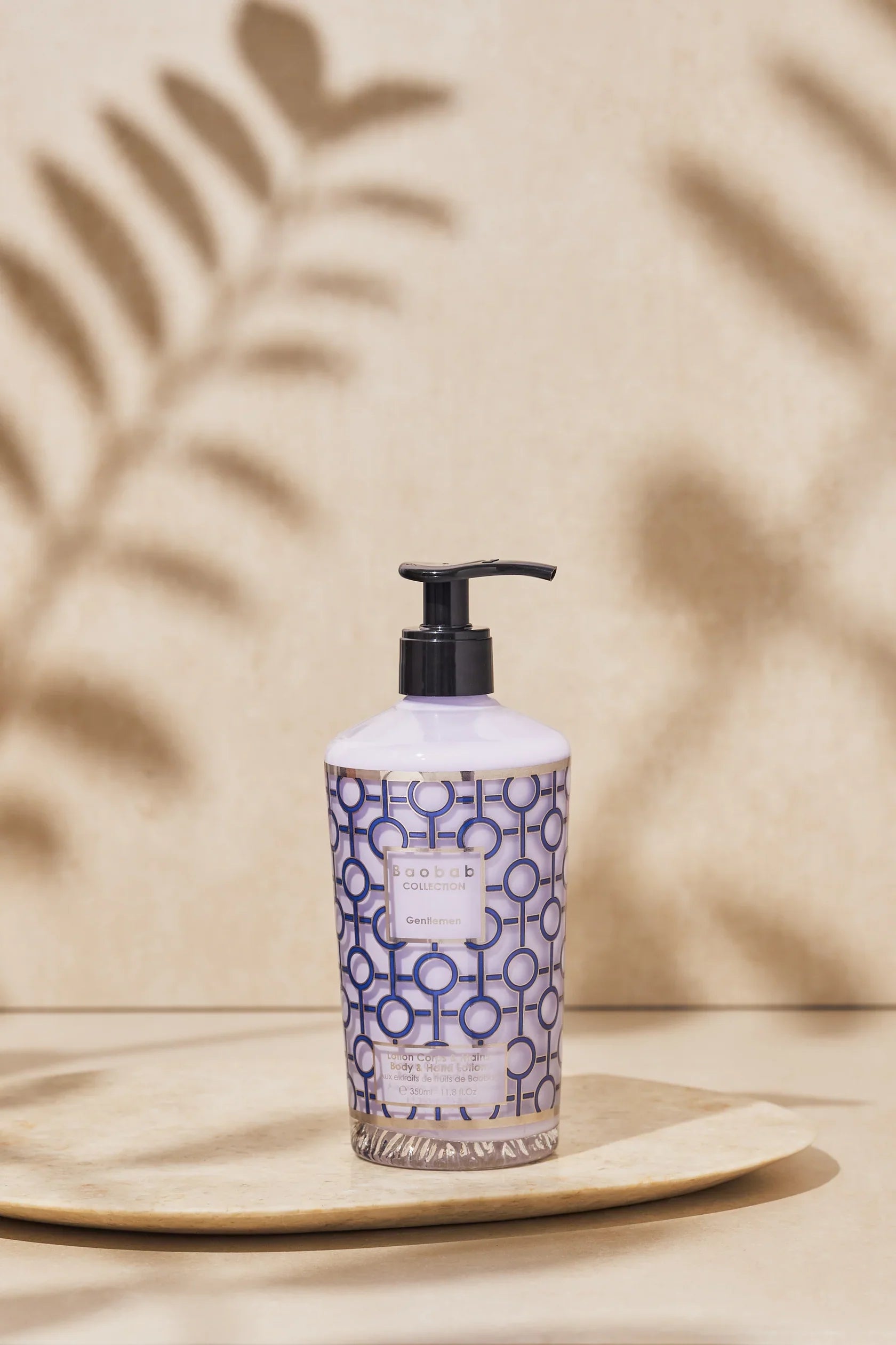 Baobab Collection Gentlemen body and hand lotion 350ml with geometric navy blue print on elegant display.