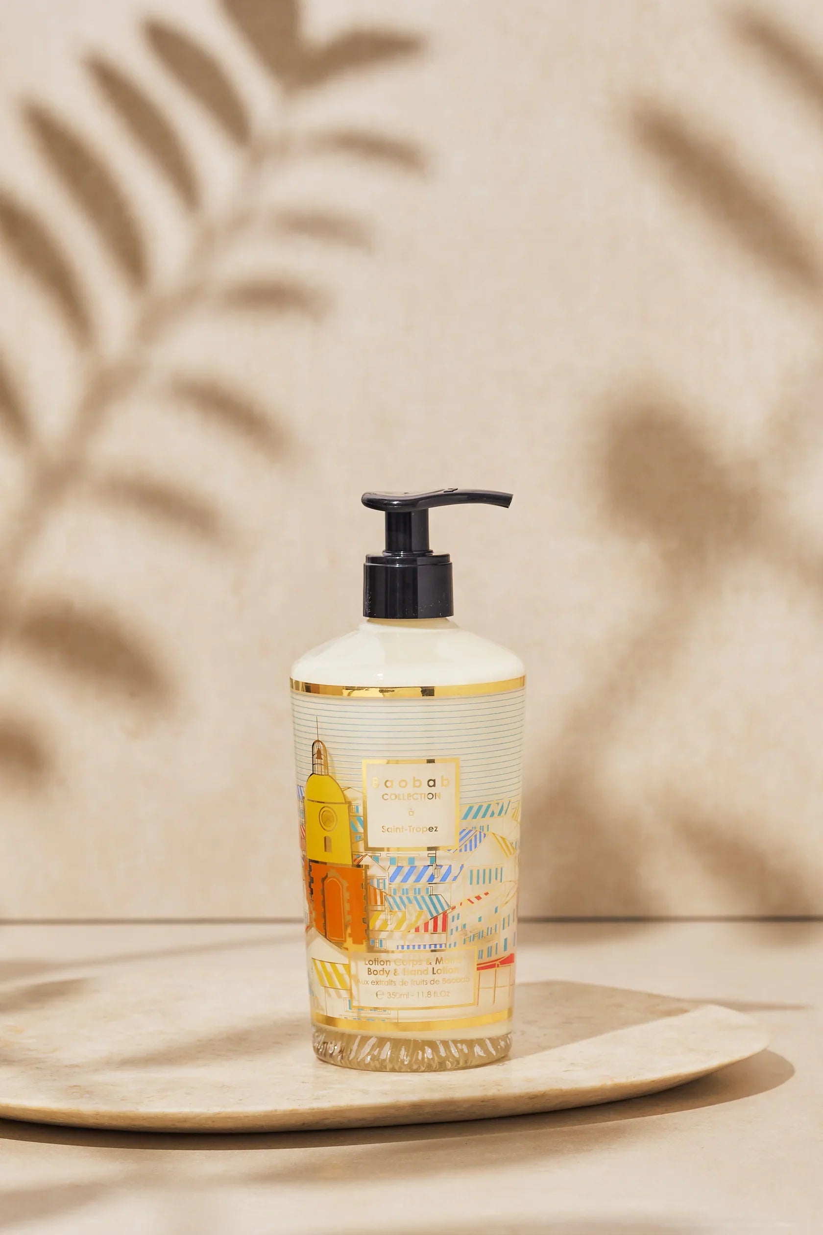 Baobab Collection Saint-Tropez hand and body lotion in stylish packaging on a decorative tray.