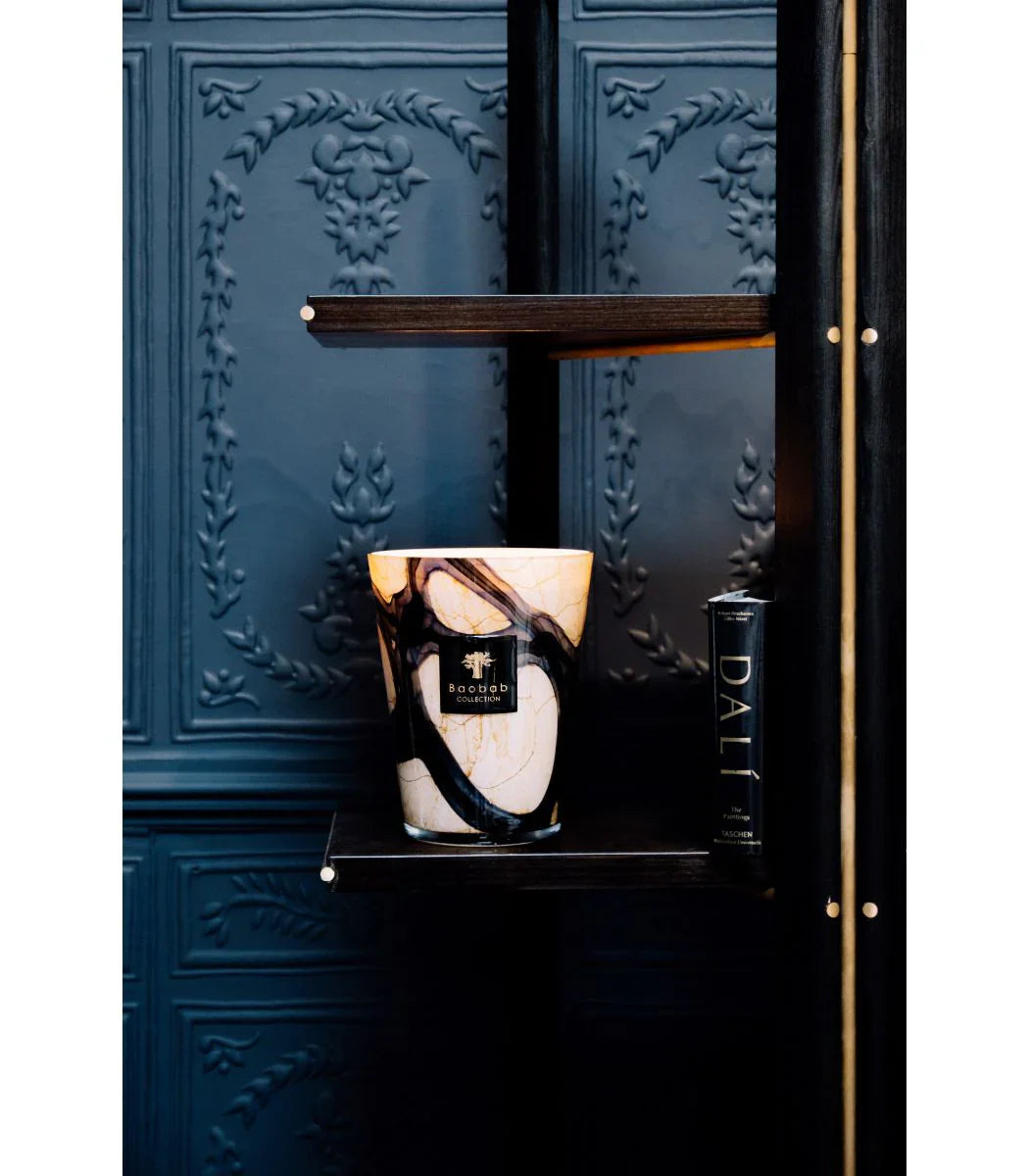 Baobab Collection Lazuli candle on a shelf, showcasing elegant marbled glass and intricate details.