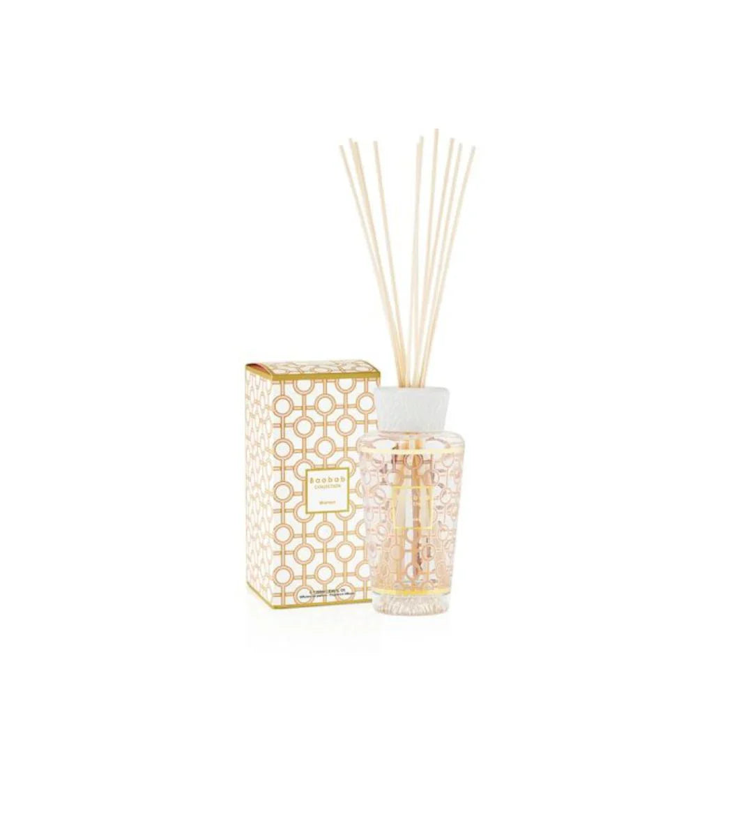 Baobab Collection diffuser in gold and powder pink, featuring feminine musk, rose, and magnolia aromas.