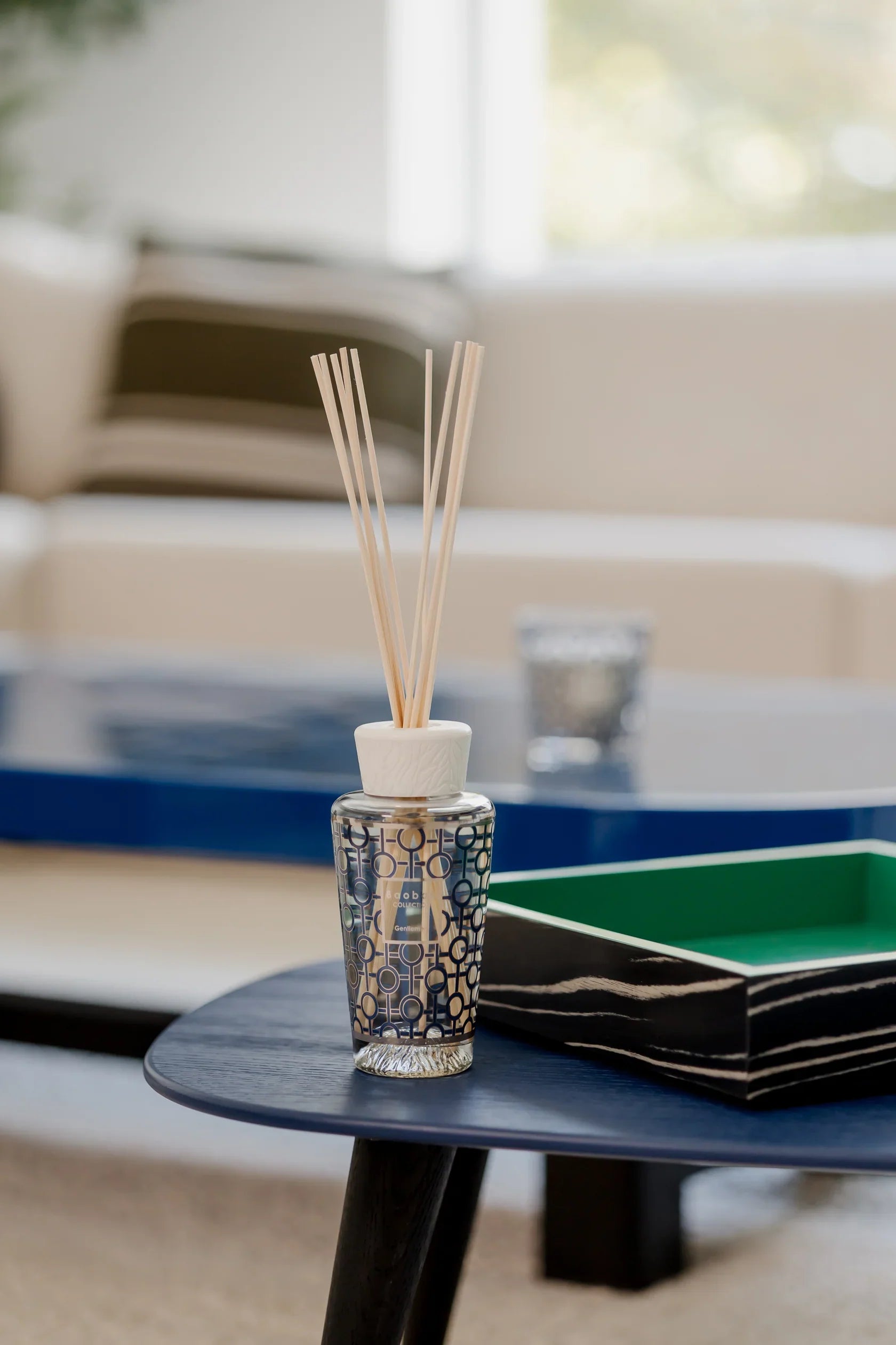 Baobab Collection diffuser My First Baobab Gentlemen with glass design on a coffee table in a stylish home setting.