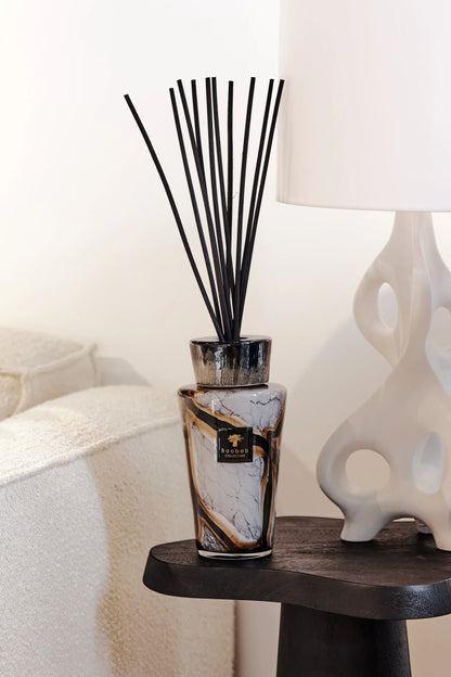 Baobab Collection Totem Stones Marble diffuser on a table, featuring black reeds and a luxurious marble design.