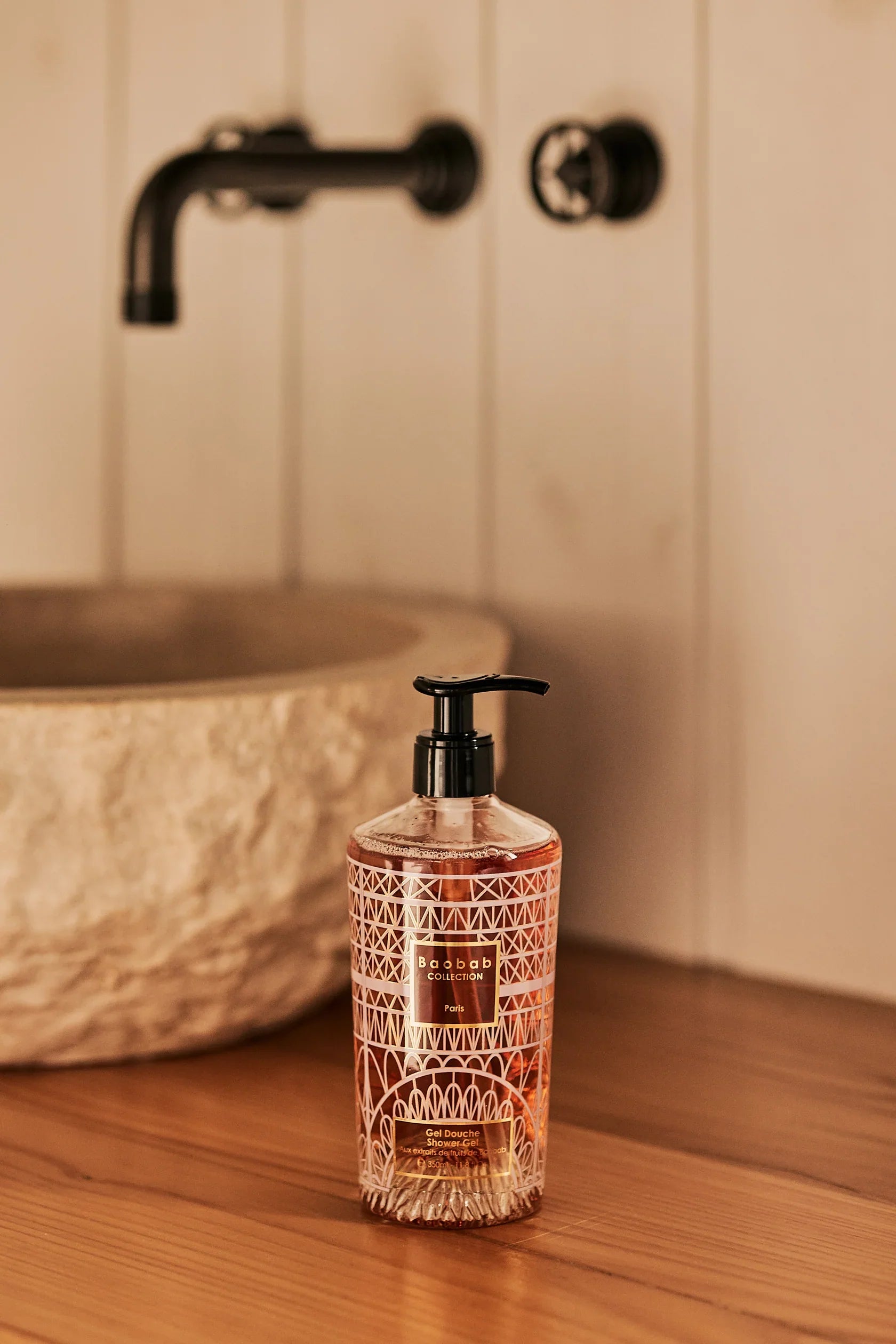 Baobab Collection Paris hand wash gel in decorative bottle, displayed near a stylish sink.