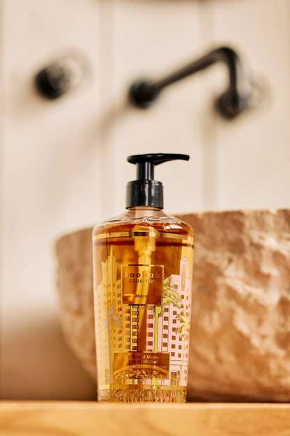 Baobab Collection hand wash gel in decorative bottle with art deco design against a stone sink background.