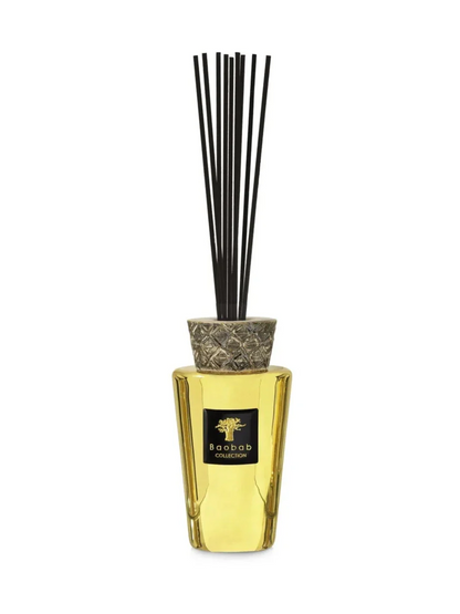 Baobab Collection TOTEM LES EXCLUSIVES AURUM diffuser with gold tint and ceramic cap, featuring black fragrance sticks.