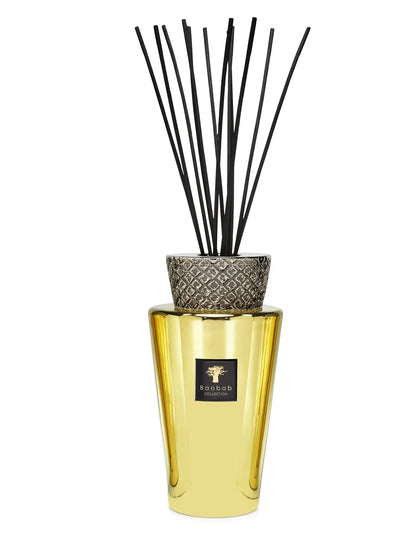 Baobab Collection's Totem Aurum fragrance diffuser with gold vase and ceramic cap, featuring black sticks for home decor.