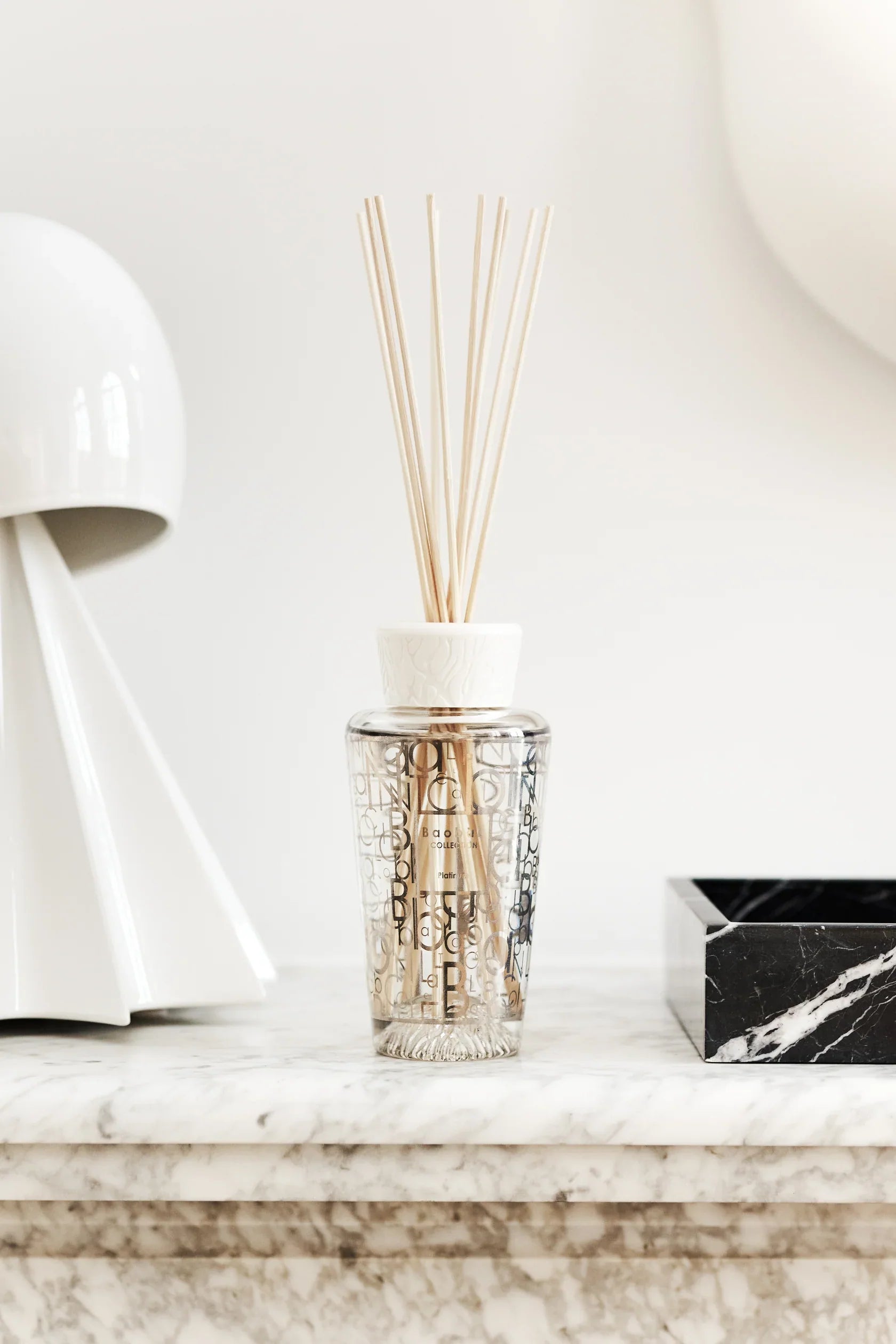 Baobab Collection My First Baobab Platinum diffuser with reeds on marble surface, featuring grapefruit, amber, and vetiver fragrance.