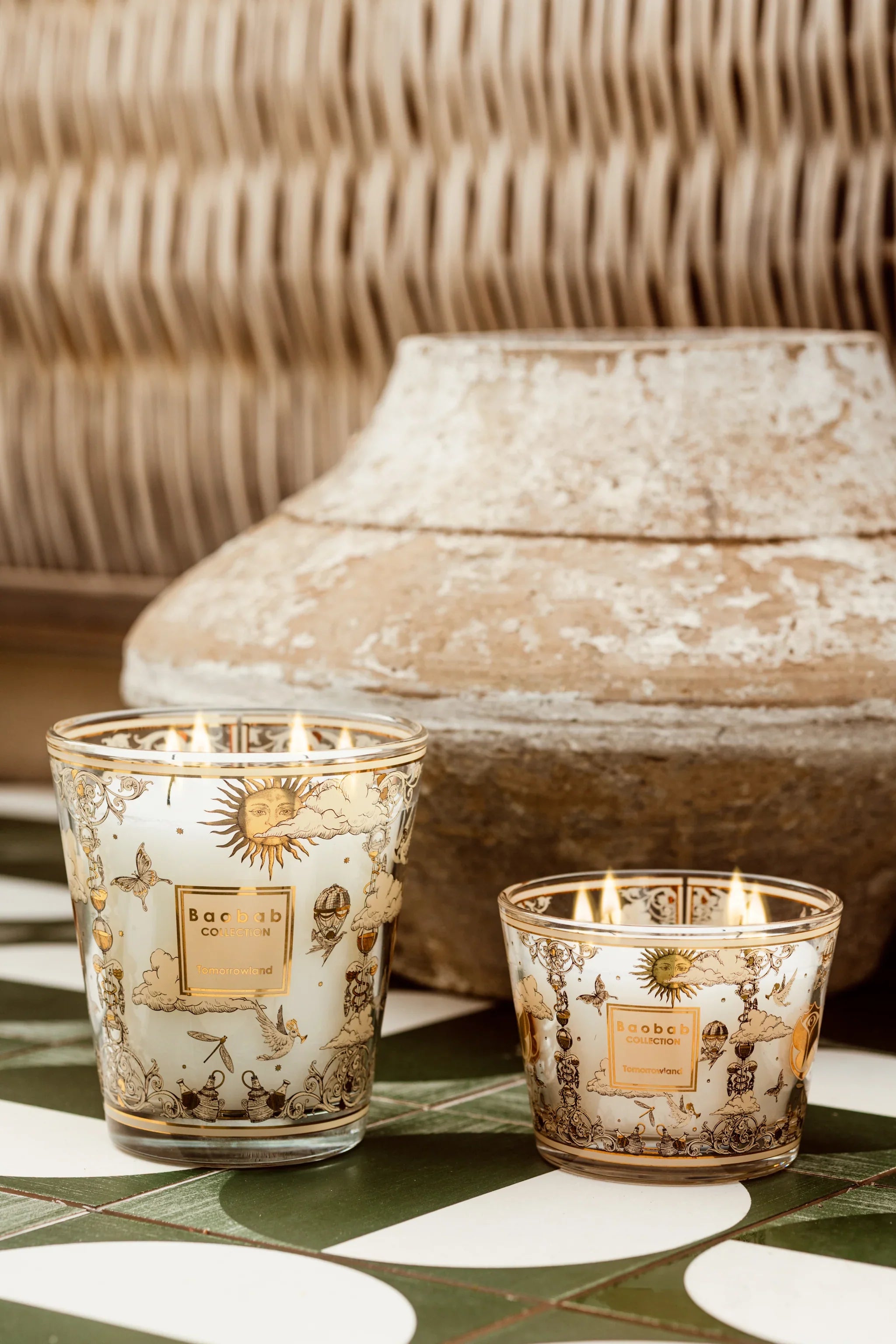 Baobab Collection scented candles with decorative glass in warm lighting, placed beside an earthen pot.