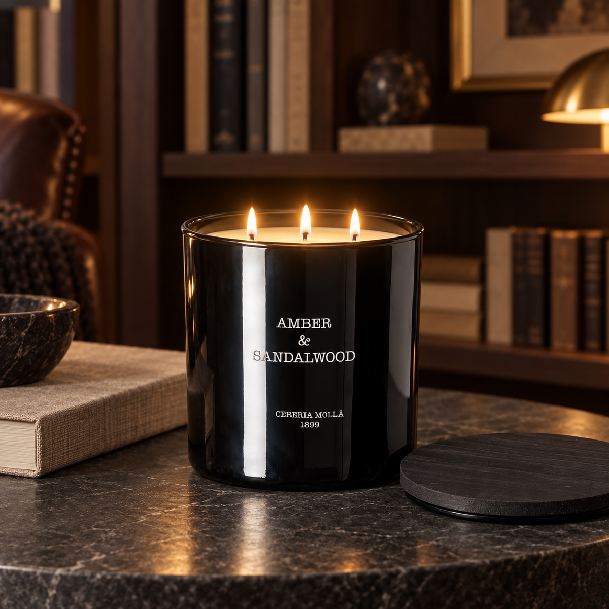 Cereria Molla Amber & Sandalwood 3-wick XL candle in an elegant library