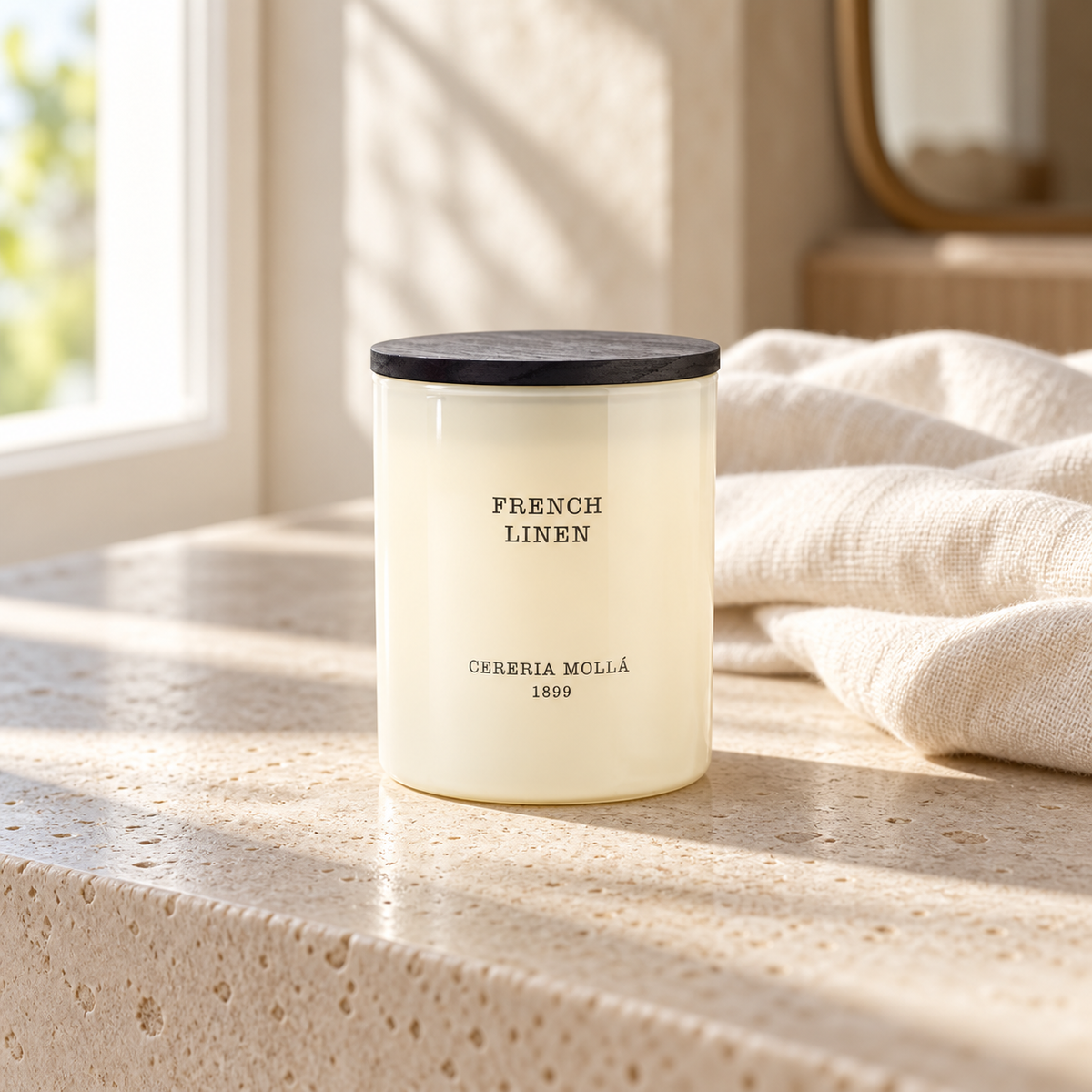Cereria Molla French Linen Ivory 230 g candle in a sunlit luxury interior