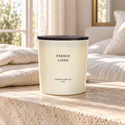 Cereria Molla French Linen Ivory XL 600 g candle in a sunlit luxury bedroom