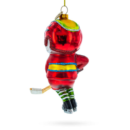 Energetic Snowman Playing Hockey Glass Christmas Ornament
