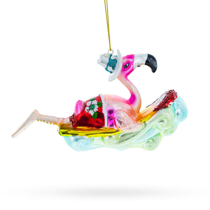 Pink Flamingo Riding a Surf Wave Glass Christmas Ornament