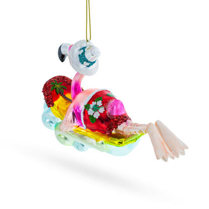 Pink Flamingo Riding a Surf Wave Glass Christmas Ornament