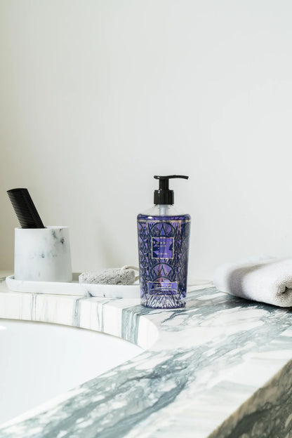 Baobab Collection Manhattan hand wash gel in decorative glass bottle on marble bathroom countertop.